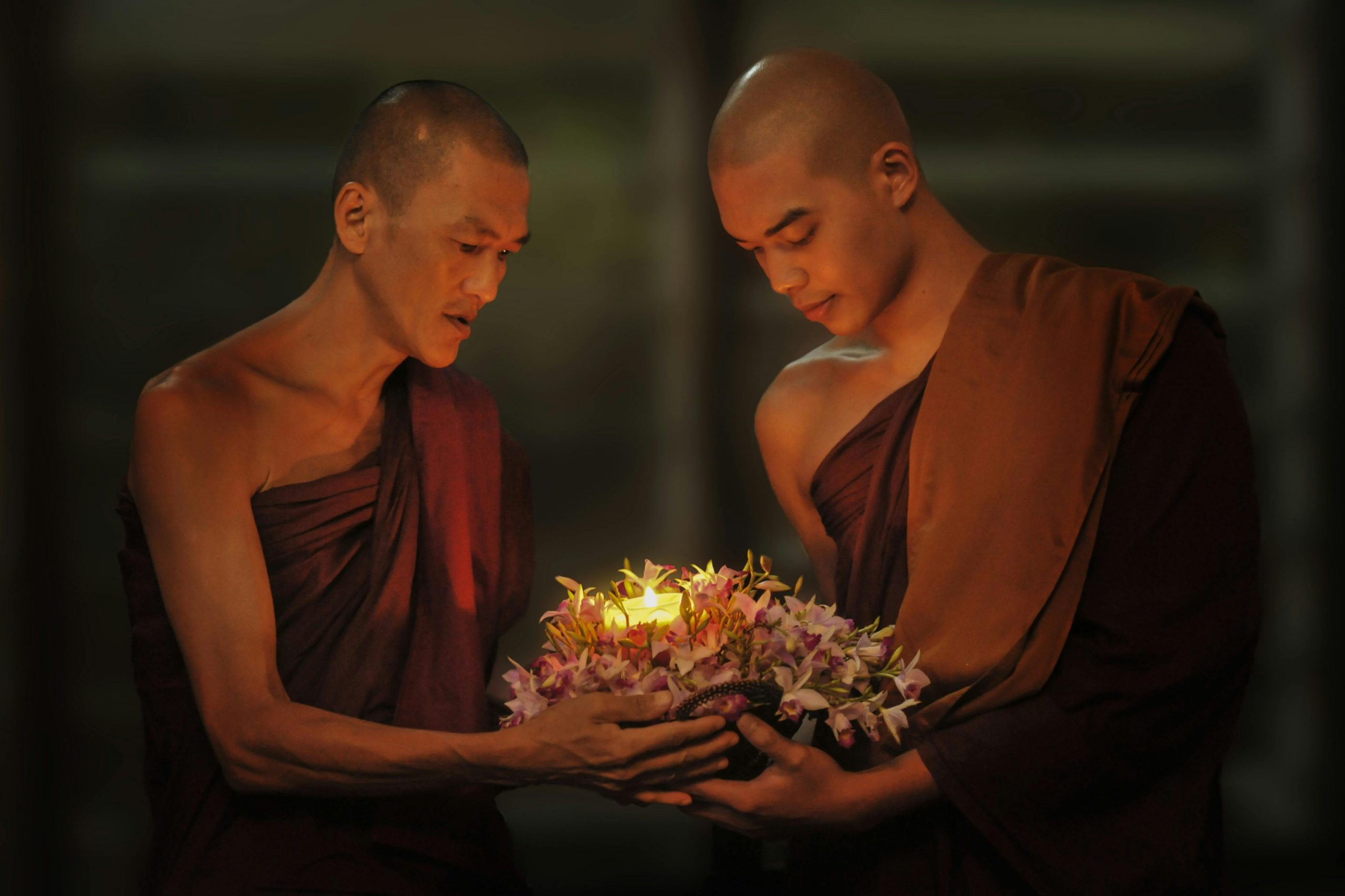 two buddhist monks preparing offerings