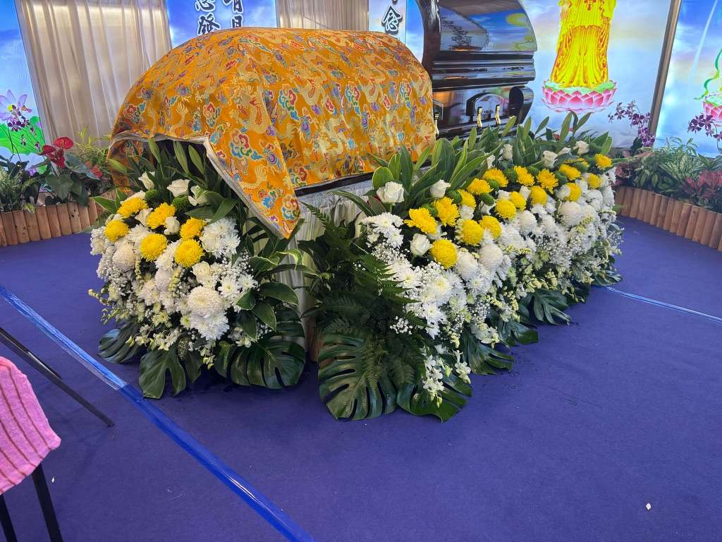 buddhist funeral casket with religious blanket done by A.LifeGrad Funeral Services in Singapore